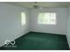 Bedroom with green carpet, white walls, and bright windows at 4667 Sundance Trl, Indianapolis, IN 46239