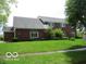 Well-maintained two-story brick home with arched windows and a lush green lawn at 4667 Sundance Trl, Indianapolis, IN 46239