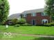 Traditional two-story brick home with well-maintained lawn and mature trees at 4667 Sundance Trl, Indianapolis, IN 46239