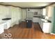 Bright kitchen featuring white cabinets, an island, and granite countertops at 4667 Sundance Trl, Indianapolis, IN 46239