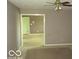 Cozy living room with ceiling fan, doorway, and neutral wall color and carpet at 4667 Sundance Trl, Indianapolis, IN 46239