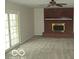 Inviting living room featuring a brick fireplace and ample natural light at 4667 Sundance Trl, Indianapolis, IN 46239