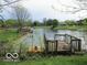 Scenic waterfront view with a wooden dock and lush greenery at 4667 Sundance Trl, Indianapolis, IN 46239