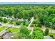 Aerial view of a suburban home in a tree-filled neighborhood showing lush greenery and well-maintained properties at 5104 Carvel Ave, Indianapolis, IN 46205