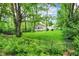 A charming house with a large backyard and lush green trees, creating a private and peaceful oasis at 5104 Carvel Ave, Indianapolis, IN 46205