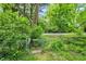 Wooded backyard with chain link fence at 5104 Carvel Ave, Indianapolis, IN 46205