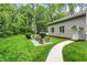 Lush backyard with a patio set, mature trees, and a well-manicured lawn at 5104 Carvel Ave, Indianapolis, IN 46205