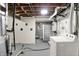 Spacious unfinished basement area with exposed ceiling, concrete flooring, and utility connections at 5104 Carvel Ave, Indianapolis, IN 46205