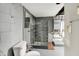 Basement bathroom with tile shower, toilet, vanity and modern fixtures at 5104 Carvel Ave, Indianapolis, IN 46205