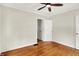 Bedroom with hardwood floors and a ceiling fan, painted in neutral colors at 5104 Carvel Ave, Indianapolis, IN 46205