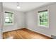 Bedroom with hardwood floors and two windows bringing in plenty of natural light at 5104 Carvel Ave, Indianapolis, IN 46205