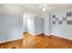Bedroom with hardwood floors and light blue walls, featuring acoustic tiles at 5104 Carvel Ave, Indianapolis, IN 46205