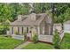 Charming cottage-style home with a white picket fence and lush greenery at 5104 Carvel Ave, Indianapolis, IN 46205