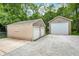 A detached two-car garage and one-car garage with gravel driveway and additional concrete parking at 5104 Carvel Ave, Indianapolis, IN 46205