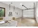 Spacious garage interior featuring painted floor, ample room for parking, and comfortable seating area with windows at 5104 Carvel Ave, Indianapolis, IN 46205