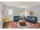 Bright living room boasts new furniture, hardwood floors, and natural light at 5104 Carvel Ave, Indianapolis, IN 46205
