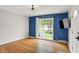Well-lit room with hardwood floors, a large window, and neutral wall colors at 5104 Carvel Ave, Indianapolis, IN 46205
