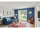 Bright living room with large window, stylish furniture and an elegant area rug at 5104 Carvel Ave, Indianapolis, IN 46205