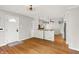 Open-concept living area with hardwood floors, neutral walls, and a kitchen view at 5104 Carvel Ave, Indianapolis, IN 46205