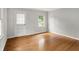 Empty living room with hardwood floors, fresh paint, and plenty of natural light at 5104 Carvel Ave, Indianapolis, IN 46205