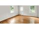 Bright room with wood floors, big windows, and a white painted door at 5104 Carvel Ave, Indianapolis, IN 46205