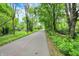 Scenic view of a paved trail surrounded by lush greenery and trees, inviting for a peaceful walk or bike ride at 5104 Carvel Ave, Indianapolis, IN 46205