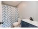 Bright bathroom featuring blue chevron shower curtain, white toilet and vanity sink at 521 Sunset Dr, Edinburgh, IN 46124
