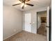 Neutral bedroom featuring a ceiling fan with light, carpeted floors, gray walls, and a doorway view to living room at 521 Sunset Dr, Edinburgh, IN 46124