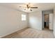 Inviting bedroom with neutral carpeting, natural light, ceiling fan, and an attached bathroom at 521 Sunset Dr, Edinburgh, IN 46124