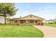 Cozy one-story home featuring a stone exterior, inviting front porch, and a green lawn at 521 Sunset Dr, Edinburgh, IN 46124
