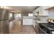 Updated kitchen boasting stainless steel appliances, stylish wood flooring, and ample cabinet space at 521 Sunset Dr, Edinburgh, IN 46124