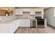 Modern kitchen with white cabinets, stainless steel appliances, light countertops, and wood-look flooring at 521 Sunset Dr, Edinburgh, IN 46124