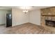 Cozy living room area with hardwood floors, a stone fireplace, and modern lighting at 521 Sunset Dr, Edinburgh, IN 46124