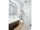 A clean bathroom features tile flooring, vanity and medicine cabinet with storage at 5416 Straw Hat Dr, Indianapolis, IN 46237