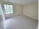 Bright, empty bedroom with neutral carpet and a large window to provide natural light at 5416 Straw Hat Dr, Indianapolis, IN 46237