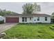 Inviting single-story home with vinyl siding, attached garage, and a neat front yard with green grass at 5416 Straw Hat Dr, Indianapolis, IN 46237