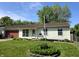 Charming single-story home with a well-manicured lawn and mature landscaping at 5416 Straw Hat Dr, Indianapolis, IN 46237