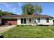 Charming single-story home with a well-manicured lawn and mature landscaping at 5416 Straw Hat Dr, Indianapolis, IN 46237