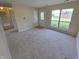 Bright living room with neutral carpet, a large window, and a front door with decorative glass at 5416 Straw Hat Dr, Indianapolis, IN 46237
