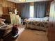 Bedroom with wood paneled walls, ceiling fan and packed cardboard moving boxes at 5585 Gallagher Dr, Greenwood, IN 46142