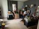 Cluttered bedroom with grey walls, stacked cardboard boxes and unorganized personal belongings at 5585 Gallagher Dr, Greenwood, IN 46142