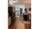 Galley kitchen featuring wood floors, stainless steel refrigerator, and ample counter space at 5585 Gallagher Dr, Greenwood, IN 46142