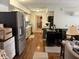 View of kitchen with wood floors and stainless steel refrigerator at 5585 Gallagher Dr, Greenwood, IN 46142