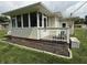 A screened-in sunroom extends the living space with a white railing and a cozy porch to enjoy the backyard view at 5585 Gallagher Dr, Greenwood, IN 46142