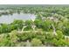 A serene aerial view of a lakeside home and its lush green surroundings at 5786 E Fall Creek Pkwy N Dr, Indianapolis, IN 46226