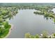 Wide aerial view showcasing a peaceful lake surrounded by lush green landscape and trees at 5786 E Fall Creek Pkwy N Dr, Indianapolis, IN 46226