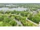 Scenic aerial view showcases lakeside homes surrounded by lush trees and landscape at 5786 E Fall Creek Pkwy N Dr, Indianapolis, IN 46226