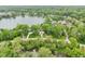 Beautiful aerial view featuring a lakeside property with lush trees at 5786 E Fall Creek Pkwy N Dr, Indianapolis, IN 46226