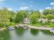 Beautiful lakeside home boasting mature trees, manicured lawns, a private dock, and in-ground pool at 5786 E Fall Creek Pkwy N Dr, Indianapolis, IN 46226