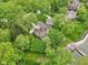 An aerial view of a beautiful home tucked away among lush greenery near the lake at 5786 E Fall Creek Pkwy N Dr, Indianapolis, IN 46226